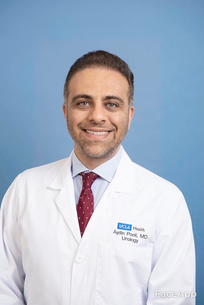 Dr. Aydin Pooli, a urologist at UCLA Health, smiles for the camera in a white lab coat